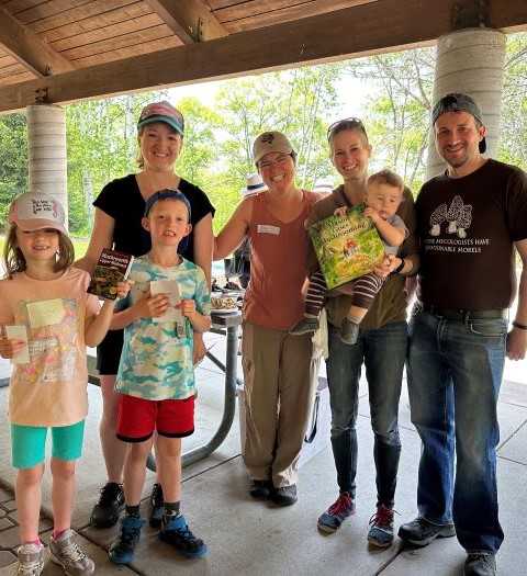 A family at the MMS's Family Funal Fair with author Melany Kahn